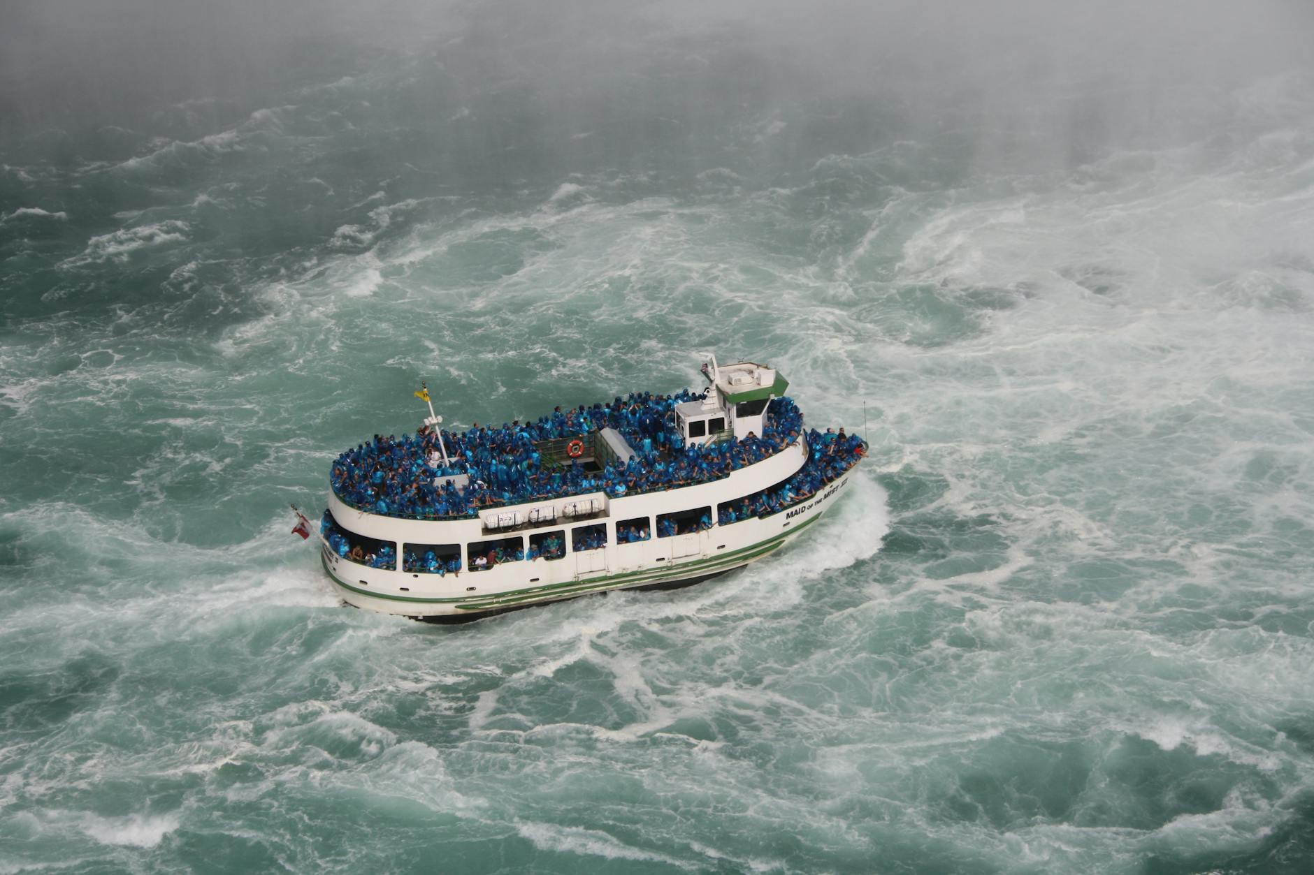 tourists riding the maid of the mist boat in niagara falls