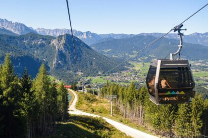 cableway in forested mountains on sunny day